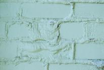 paint failure caused by dampness in bricks